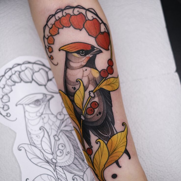 Tattoo Autumn Woodpecker in floral motif and neo-traditional style on the forearm