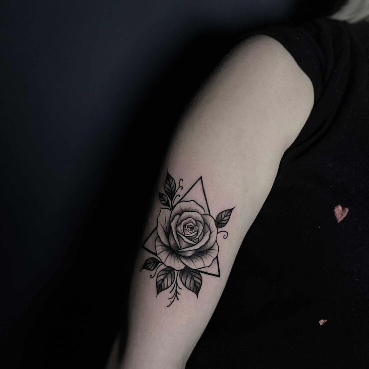 Tattoo Rose in a triangle in black and gray motif and graphic / illustrative style on the upper arm