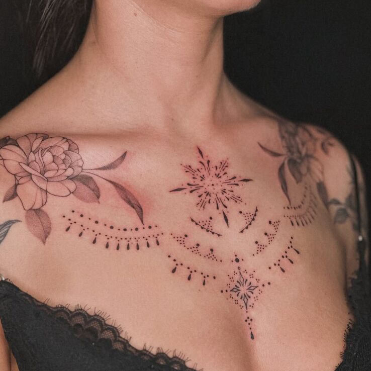 Tattoo Ornamental chest tattoo in black and gray motif and contour / linework style on the chest