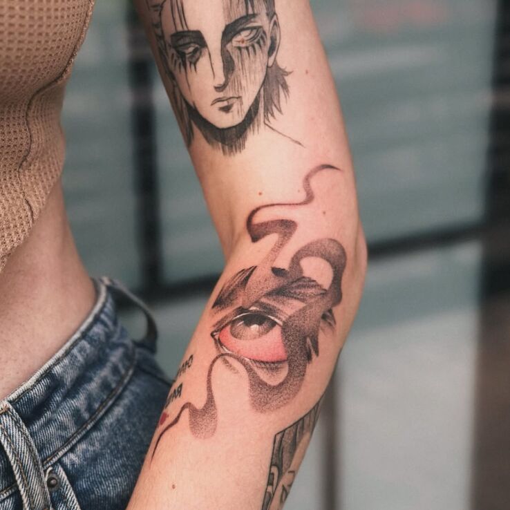 Tattoo Abstraction with an Eye in black and gray motif and graphic / illustrative style On the arm