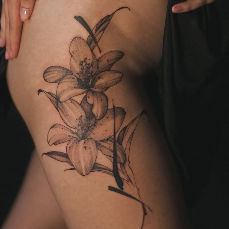 Tattoo Lilies touched with a black stroke in black and gray motif and graphic / illustrative style on the hip