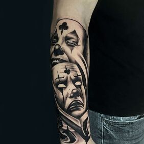 Tattoo Clown masks - joy and sorrow on the forearm motif: black and gray style: graphic / illustrative