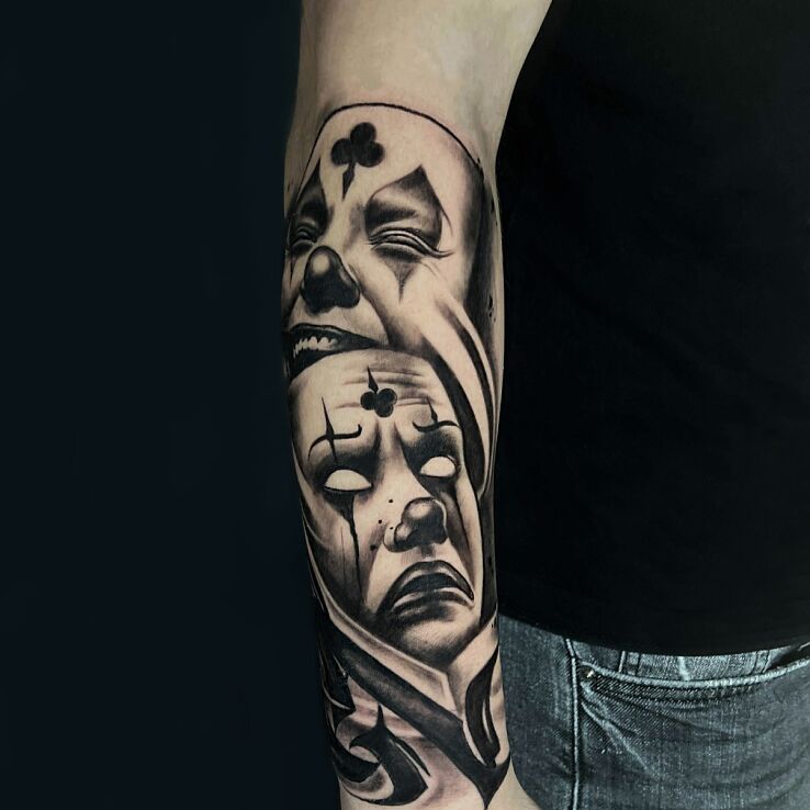 Tattoo Clown masks - joy and sorrow in faces motif and graphic / illustrative style On the arm