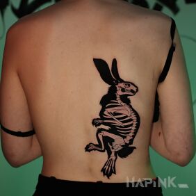 Tattoo Dark cover-up rabbit skeleton on the back motif: black and gray style: graphic / illustrative