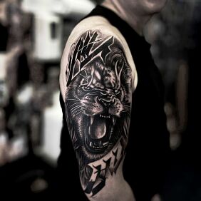 Tattoo Lion and its Roar On the arm motif: lettering style: realistic