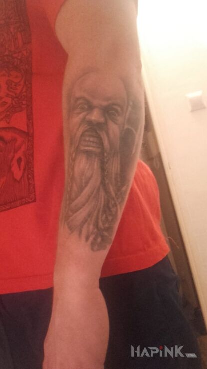 Tattoo Wiking in faces motif on the forearm