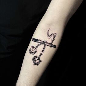 Tattoo Cigarette with dangling dice On the arm style: graphic / illustrative