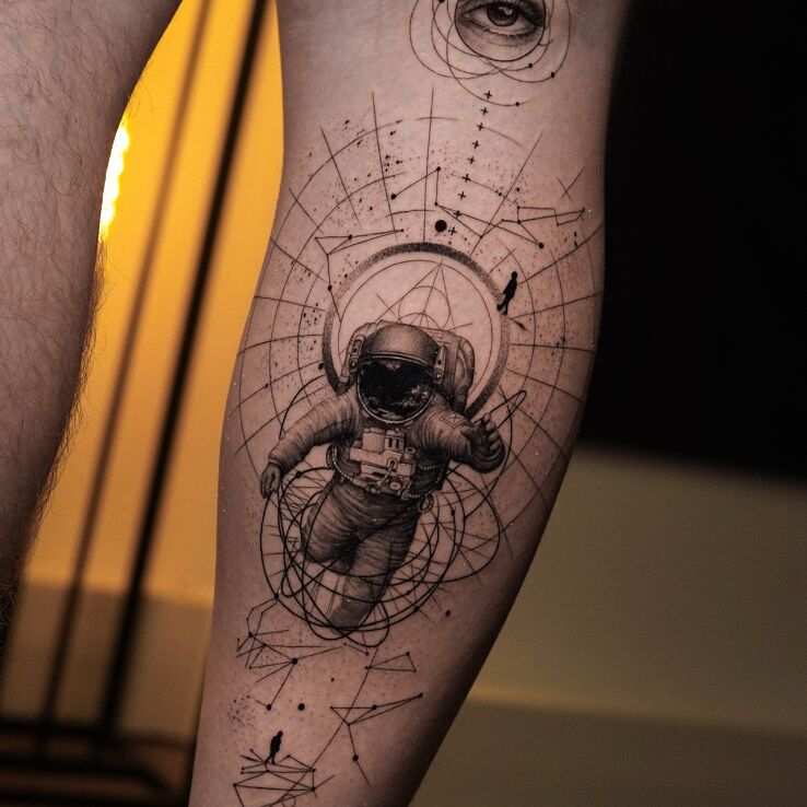 Tattoo Astronaut and Eye - Surrealistic Space Tattoo in cosmos motif and geometric style on the leg