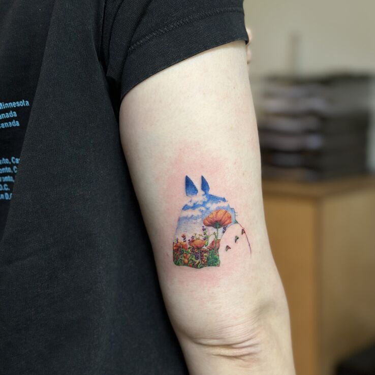 Tattoo Totoro - Illustrative Landscape in Silhouette in manga / anime motif and graphic / illustrative style on the upper arm