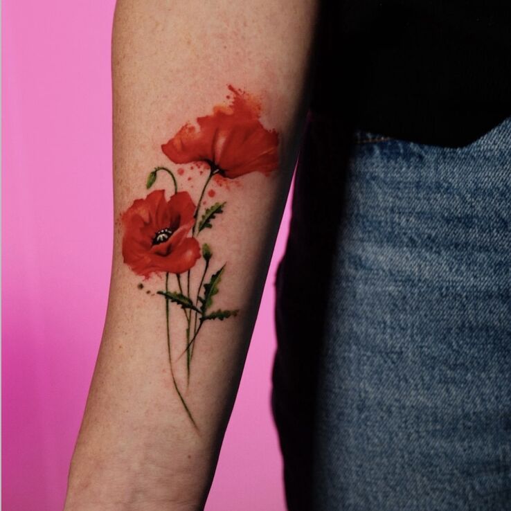 Tattoo The Red of Field Poppies in floral motif and realistic style on the forearm