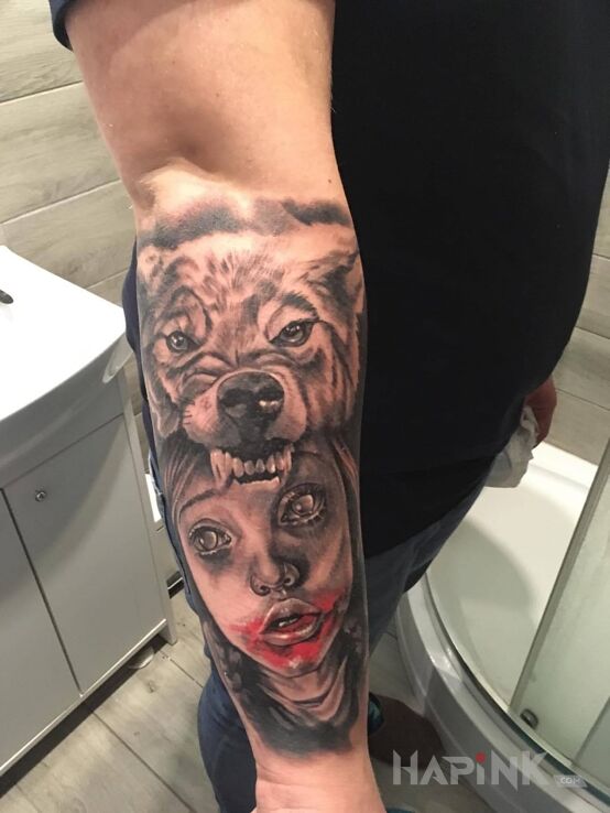 Tattoo Wilczek in faces motif and realistic style on the forearm