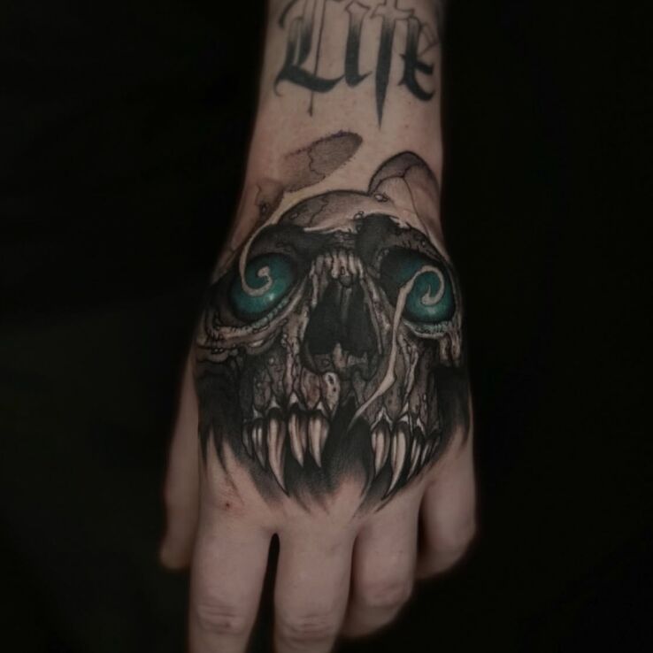 Tattoo Ominous Skull with Blue Eyes in colorful motif and graphic / illustrative style On the arm