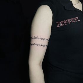 Tattoo Barbed Wire Around the Arm on the bicep motif: black and gray style: graphic / illustrative