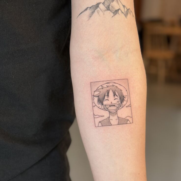Tattoo Luffy (One Piece) in a manga panel in funny motif and contour / linework style on the forearm