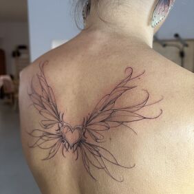 Tattoo Delicate Wings with a Heart on the shoulder blades motif: black and gray style: contour / linework