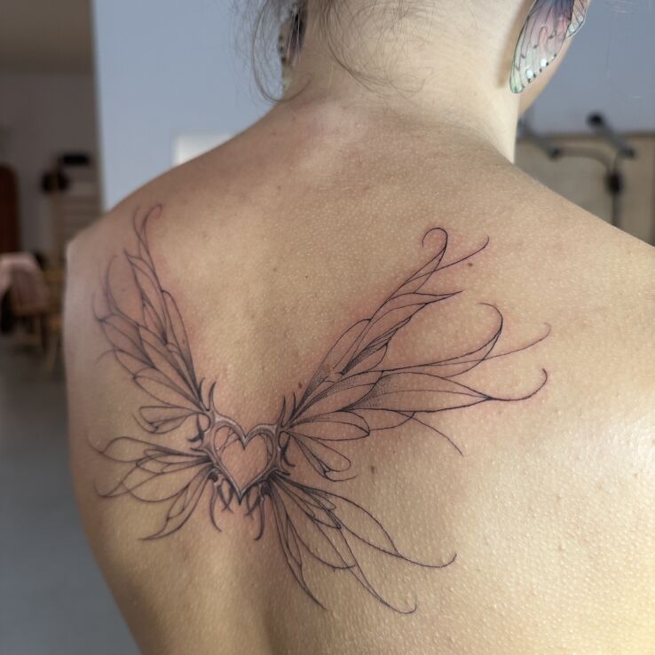 Tattoo Delicate Wings with a Heart in wings motif and contour / linework style on the back