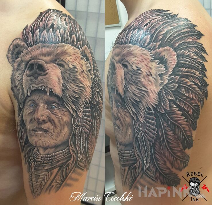 Tattoo Indianin in faces motif and realistic style on the upper arm