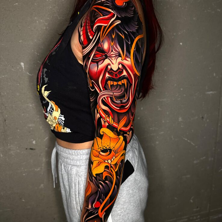 Tattoo Angry Demon with a Raven Companion in faces motif and neo-traditional style on the shoulder