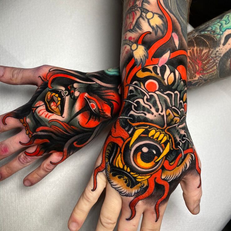 Tattoo Vampire Woman and Tiger with an Eye in its Mouth in dark motif and neo-traditional style on the hand