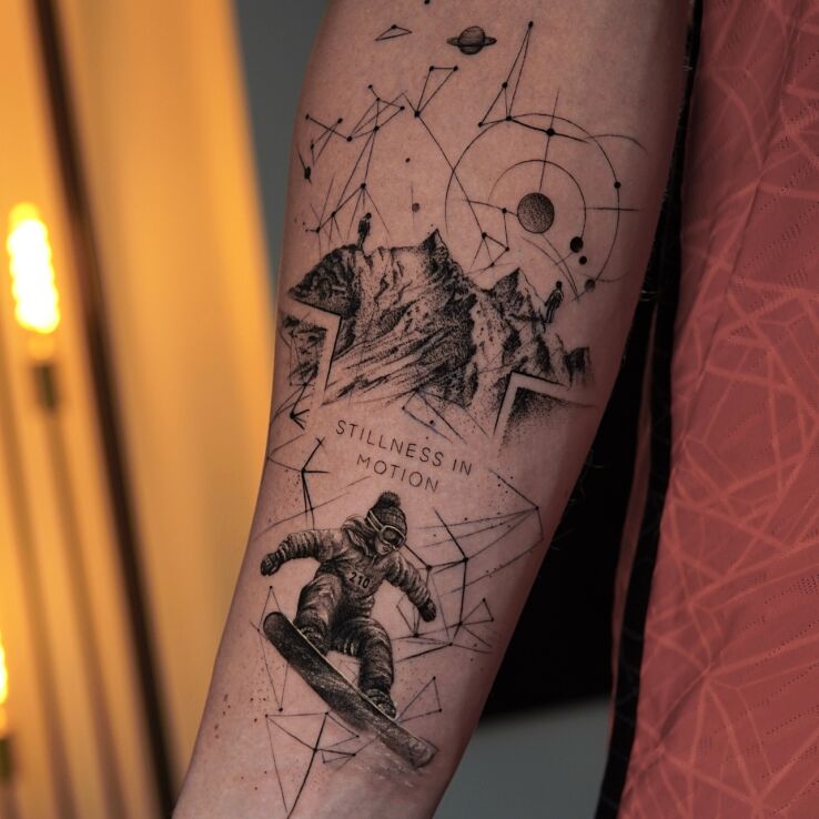 Tattoo Snowboarder vs Mountains in lettering motif and dotwork style On the arm