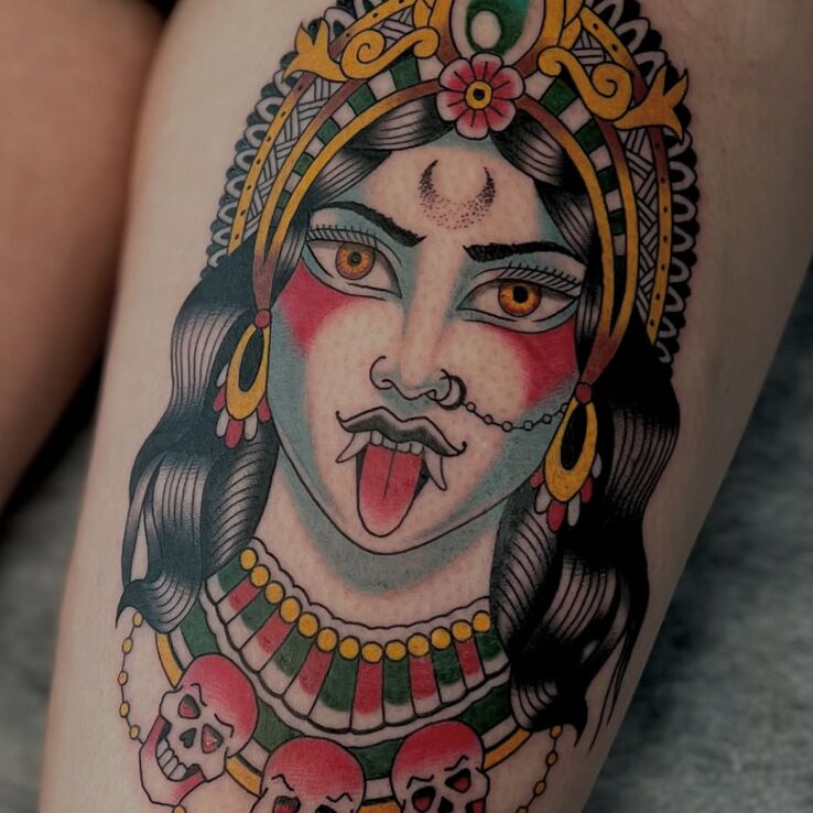 Tattoo Goddess Kali in characters motif and oldschool style on the leg