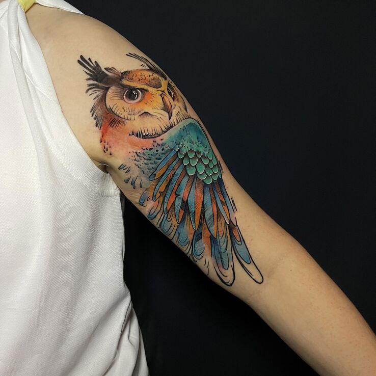 Tattoo Colorful Owl in colorful motif and graphic / illustrative style On the arm
