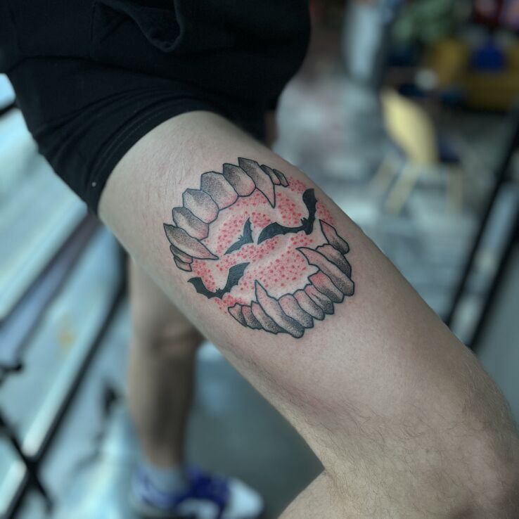 Tattoo Bats in the Jaws in colorful motif and graphic / illustrative style on the thigh