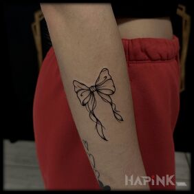 Tattoo Delicate Bow on the forearm style: graphic / illustrative