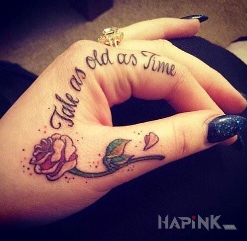 Tattoo Tale as old as time in lettering motif on the fingers