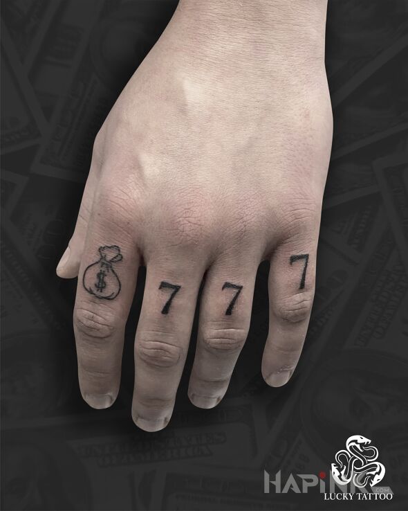 Tattoo 777 in black and gray motif and minimalistic style On the arm