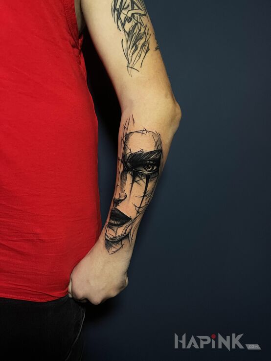 Tattoo Half woman's face sketch in faces motif and graphic / illustrative style on the forearm