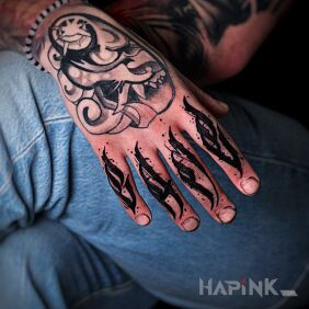 Tattoo Black calligraphy on entire fingers on the hand motif: criminal lettering style: calligraphy