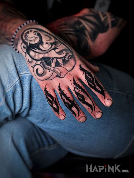 Tattoo Black calligraphy on entire fingers in criminal lettering motif and calligraphy style on the fingers