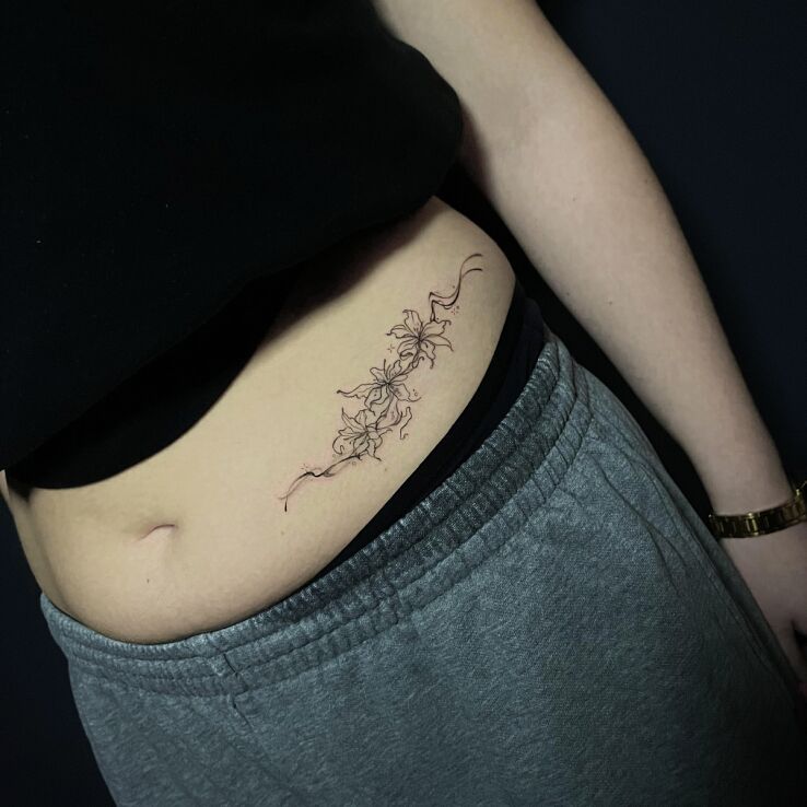 Tattoo Delicate Little Flowers in flowers motif and contour / linework style on the stomach
