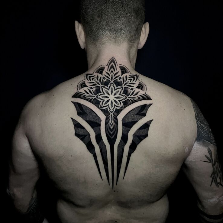 Tattoo Mandala with emerging elements in mandalas motif and dotwork style on the nape