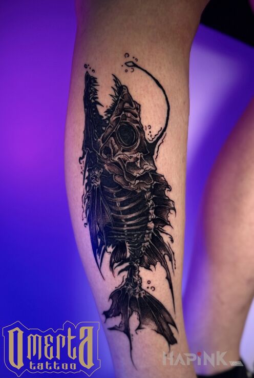 Tattoo Fish Skeleton in anatomical motif and blackwork / blackout style on the tibia