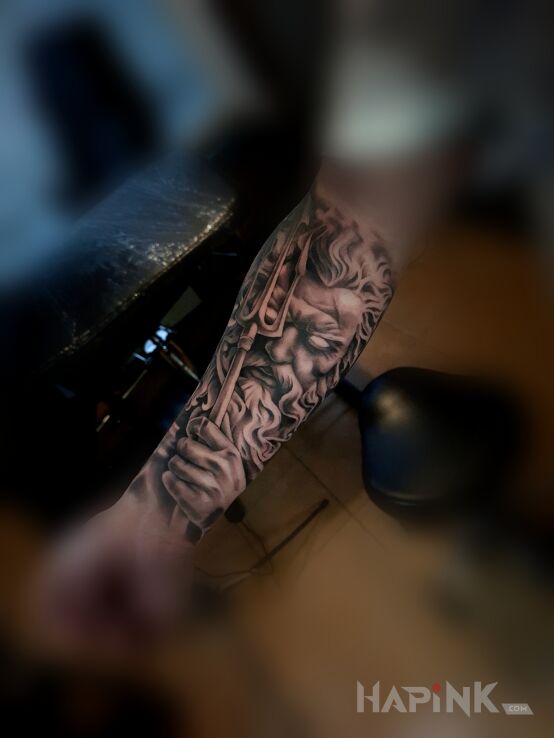 Tattoo Poseidon on the forearm in faces motif and realistic style On the arm