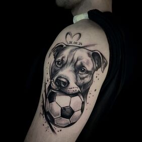 Tattoo Dog with a ball On the arm motif: black and gray style: realistic