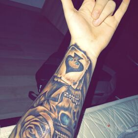 Tattoo Skull/Rose/Crown/Card on the forearm motif: skulls