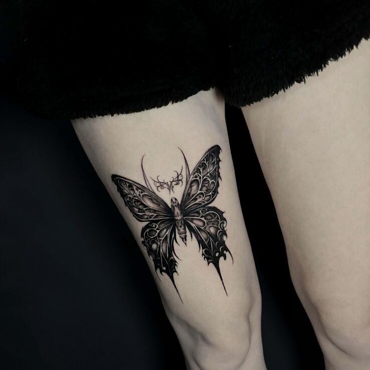 Tattoo Dark Butterfly in insects motif and graphic / illustrative style on the thigh