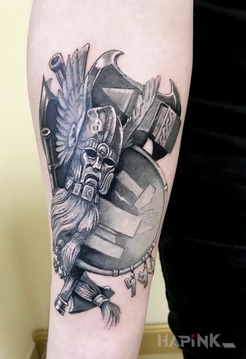 Tattoo Wojownik in faces motif on the forearm