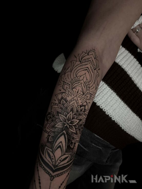 Tattoo Mandala combined with geometry in ornaments motif and graphic / illustrative style on the forearm