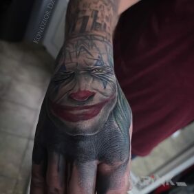 Tattoo Joker tattoo On the arm motif: faces style: realistic