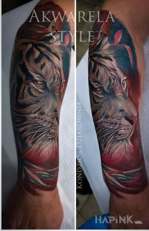 Tattoo Tiger in colorful motif and realistic style on the forearm