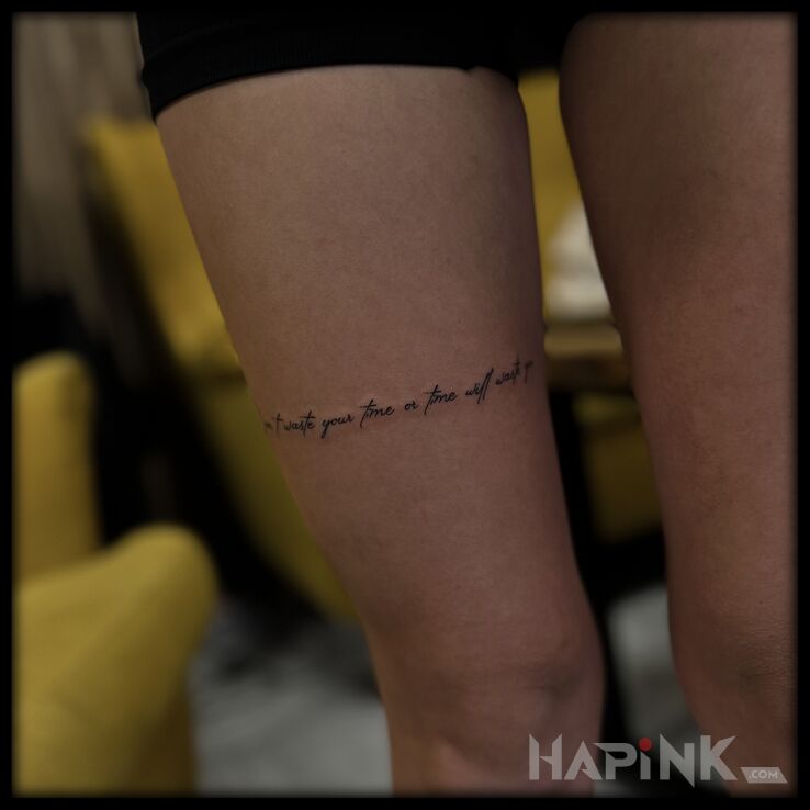 Tattoo Small inscription on the thigh in lettering motif and minimalistic style on the leg