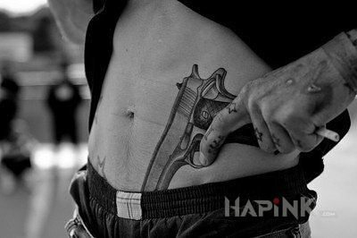Tattoo Gun in objects motif and realistic style on the stomach