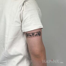 Tattoo Realistic wolf eyes tattooed as a subtle arm band. on the upper arm motif: animals style: graphic / illustrative