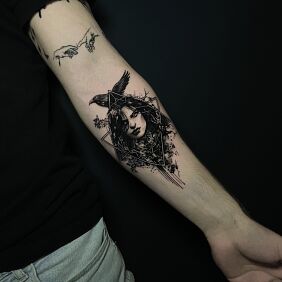 Tattoo Woman with a raven enclosed in a triangle On the arm style: graphic / illustrative