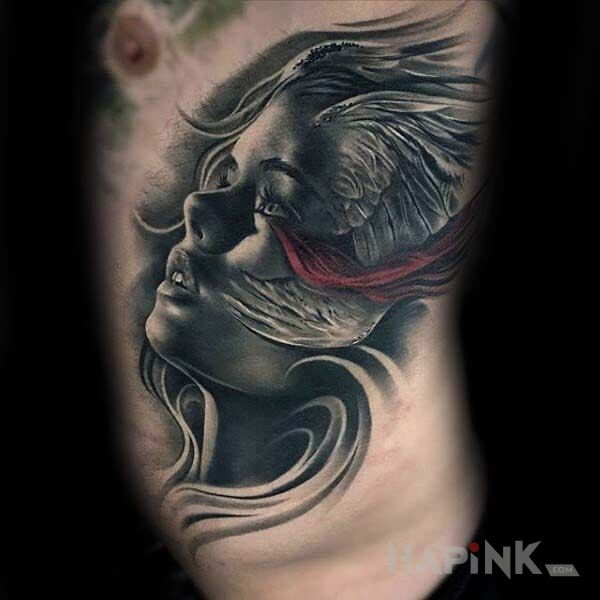 Tattoo Uskrzydlony portret in faces motif and realistic style on the ribs