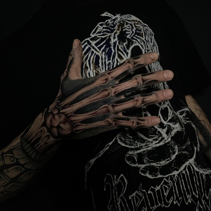Tattoo Skeleton Hand in dark motif and realistic style on the hand